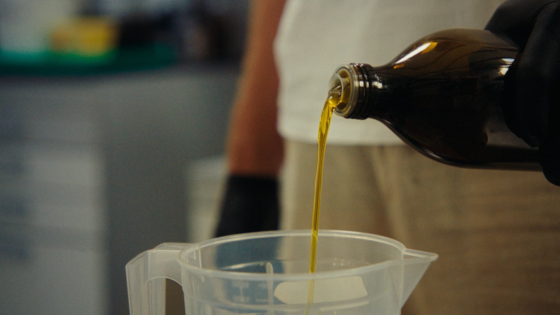 Man pouring olive oil